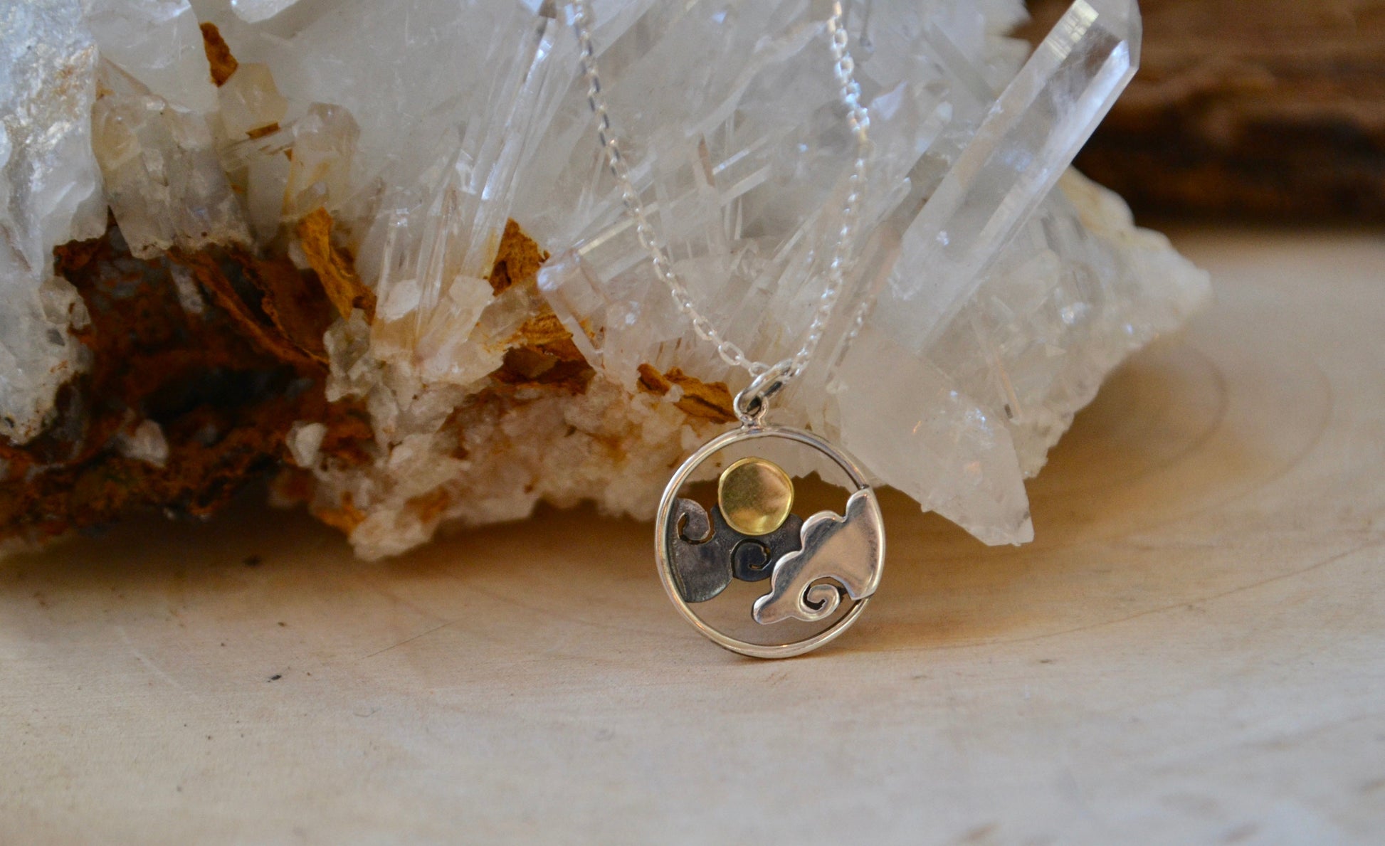 Clouds with sun necklace